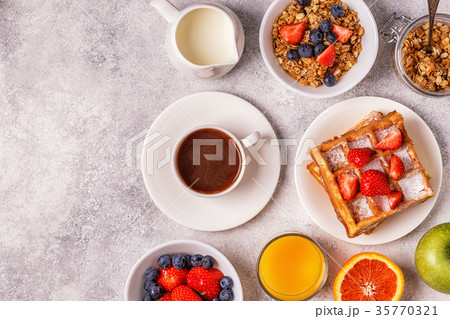 Delicious breakfast on a light table. Delicious breakfast on a light table. 35770321