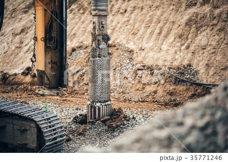 heavy duty machinery drilling holes in the ground  35771246