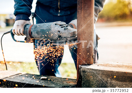 Details of worker using electric angle grinder 35772952