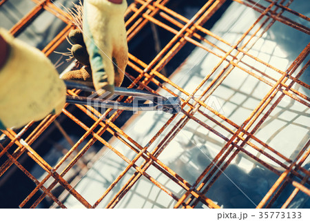 Construction site with worker using wire rod 35773133