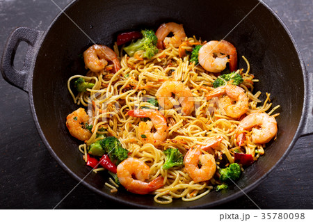 Stir fried noodles with shrimps and vegetables Stir fried noodles with shrimps and vegetables 35780098