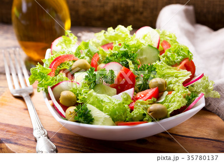 bowl of fresh salad with vegetables and greens bowl of fresh salad with vegetables and greens 35780137