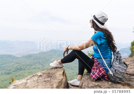 Tourist Girl With Backpack Sitting On Mountain Top 35788995