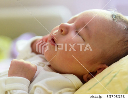 Newborn girl sleeping peacefully Newborn girl sleeping peacefully 35793328
