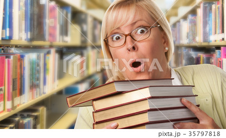 Beautiful Expressive Student or Teacher with Books in Library. 35797818