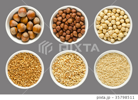 Hazelnuts, whole and processed nuts in white bowls Hazelnuts, whole and processed nuts in white bowls 35798511