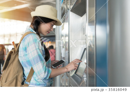 woman using phone pay to buy ticket 35816049