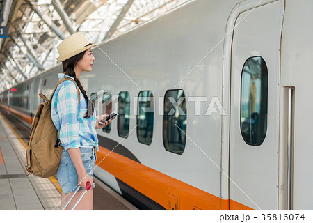 Asian waiting for arrival on the train platform. Asian waiting for arrival on the train platform. 35816074