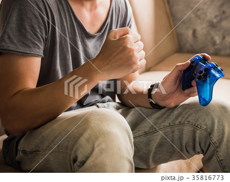 young gamer playing the video game with a joystick 35816773
