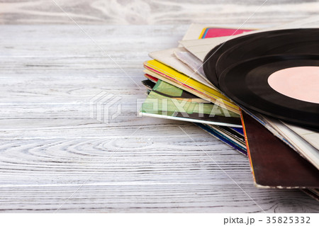 Old vinyl record on wooden background. Retro style 35825332
