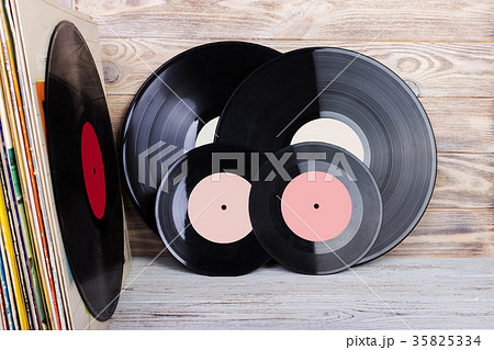 Vinyl record in front of a collection of albums 35825334