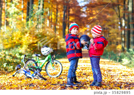 Two little kid boys with bicycles in autumn forest 35829895