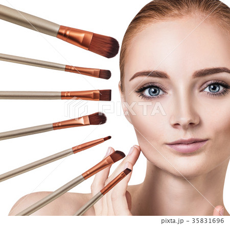 Woman's face surrounded by makeup brushes. Woman's face surrounded by makeup brushes. 35831696