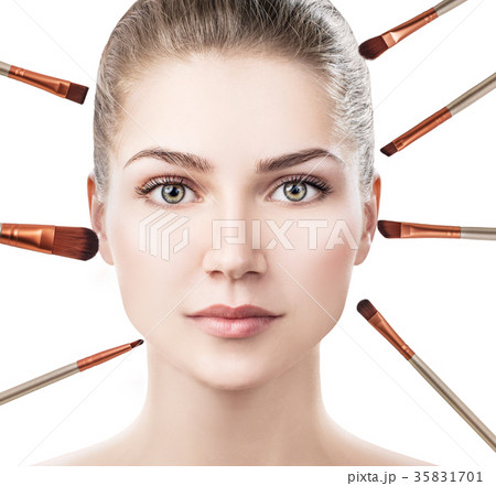 Woman's face surrounded by makeup brushes. Woman's face surrounded by makeup brushes. 35831701