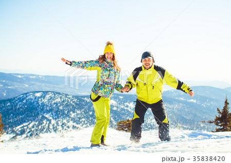 Couple jumping in the winter in the mountains Couple jumping in the winter in the mountains 35838420