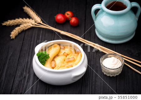 Dumplings with potatoes and cracknel on black wooden background Dumplings with potatoes and cracknel on black wooden background 35851000