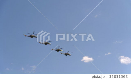 Combat helicopters Mi-24 fly in blue sky Combat helicopters Mi-24 fly in blue sky 35851368