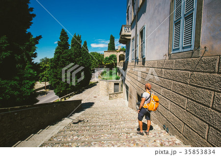 the tourist's man stands back to city of Bergamo the tourist's man stands back to city of Bergamo 35853834