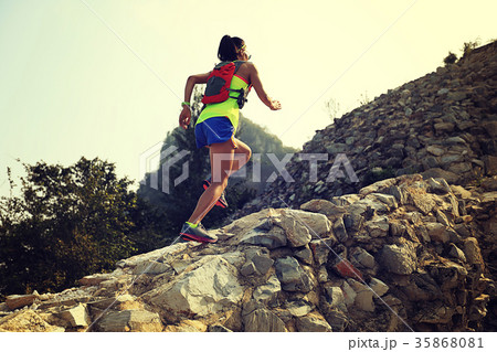 woman trail runner running on the top of mountain 35868081