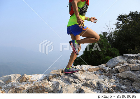 woman trail runner running on the top of mountain 35868098