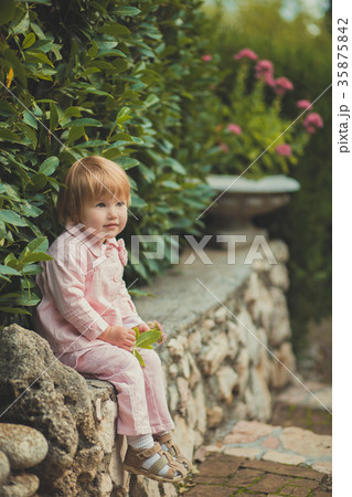 Baby cute girl with blond hair and pink apple chee 35875842