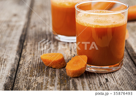 Carrot juice on a wooden table 35876493