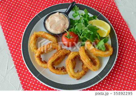 Calamari rings fried with spicy sauce.  35892295