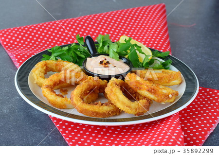 Calamari rings fried with spicy sauce Calamari rings fried with spicy sauce 35892299