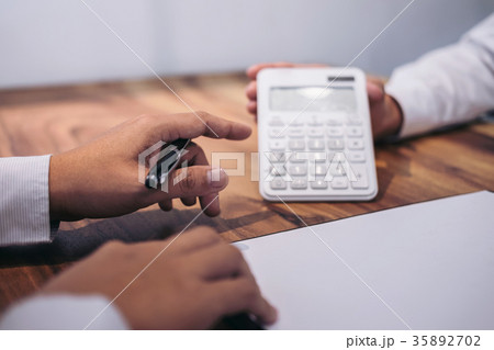Man sign a home insurance policy on home loans, Agent agent hold 35892702