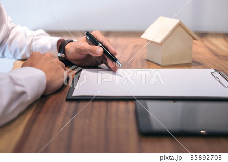Man sign a home insurance policy on home loans, Businessman sign 35892703
