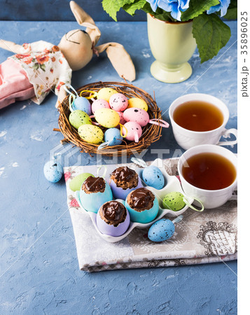 Easter sweet cup cakes treets in egg shell on blue 35896025