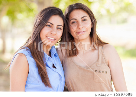 Two Beautiful Ethnic Twin Sisters Portrait Outdoors. Two Beautiful Ethnic Twin Sisters Portrait Outdoors. 35897099