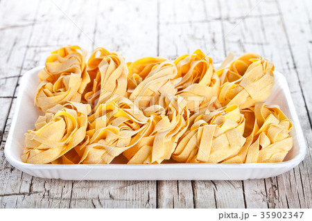 raw egg pasta in a plate raw egg pasta in a plate 35902347