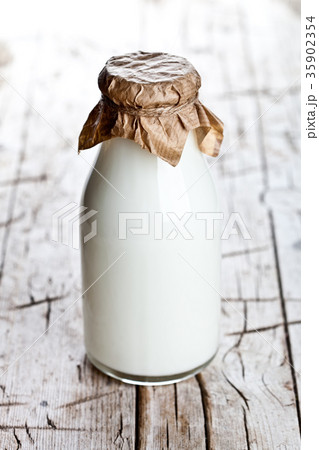 bottle of fresh milk on wooden background bottle of fresh milk on wooden background 35902354