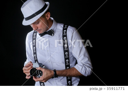 Young stylish man with photo camera Young stylish man with photo camera 35911771