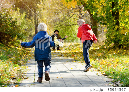 Boys running towards her mother. Autumn Park Boys running towards her mother. Autumn Park 35924547