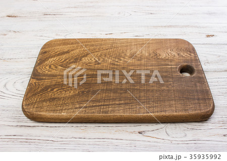 Wooden chop board on rustic wooden table top. Wooden chop board on rustic wooden table top. 35935992