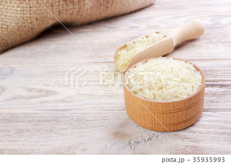 Rice in a bowl on wooden background Rice in a bowl on wooden background 35935993