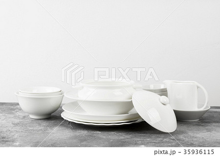 Clean white tableware on a gray background Clean white tableware on a gray background 35936115