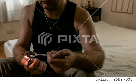 Anonymous man cooking heroin 35937906