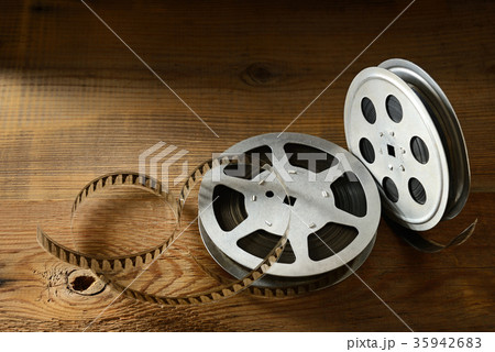 Old film strip on wooden background. Top view. 35942683