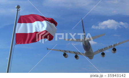 Commercial airplane landing behind waving Austrian 35943142