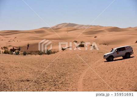 モロッコ サハラ砂漠を走る4輪駆動車の写真素材