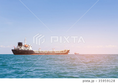 Transport cargo ship over seacoast skyline 35959128