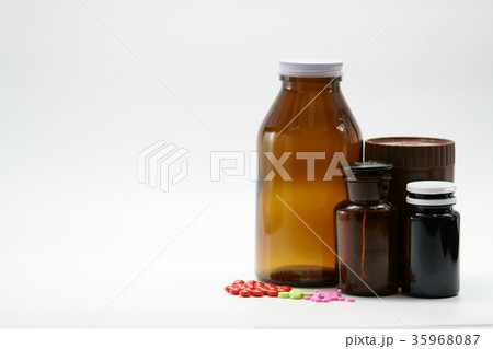 Pills and amber bottles on white background Pills and amber bottles on white background 35968087