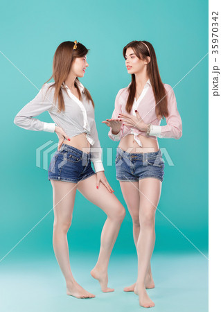 sisters twins on blue background.  35970342