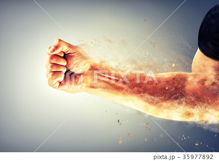 a strong man's hand bent into a fist crumbles on 35977892