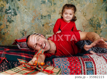 Father and daughter are fighting for a gift on the Father and daughter are fighting for a gift on the 35982223
