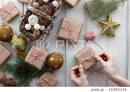 Wrapping Christmas presents and gift boxes in 35983336