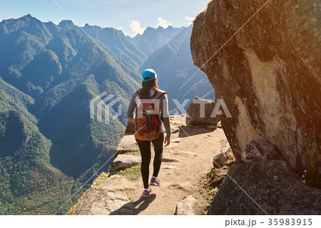 Woman walk on narrow mountain path Woman walk on narrow mountain path 35983915